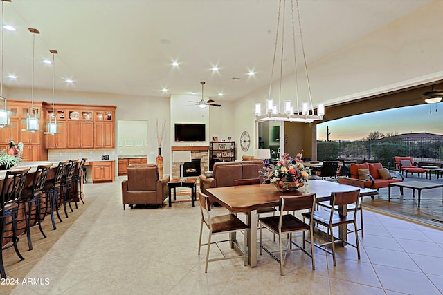 dining space featuring a stone fireplace, light tile patterned flooring, recessed lighting, and ceiling fan