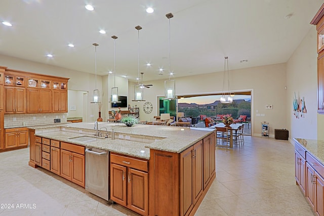 kitchen with a spacious island, a sink, decorative backsplash, stainless steel dishwasher, and open floor plan