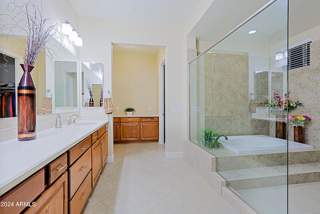 full bath with tile patterned floors, a shower stall, vanity, and a garden tub