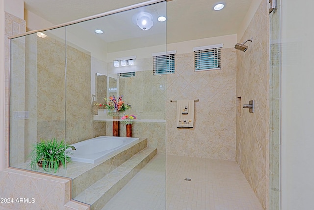 full bath featuring a bath and tiled shower