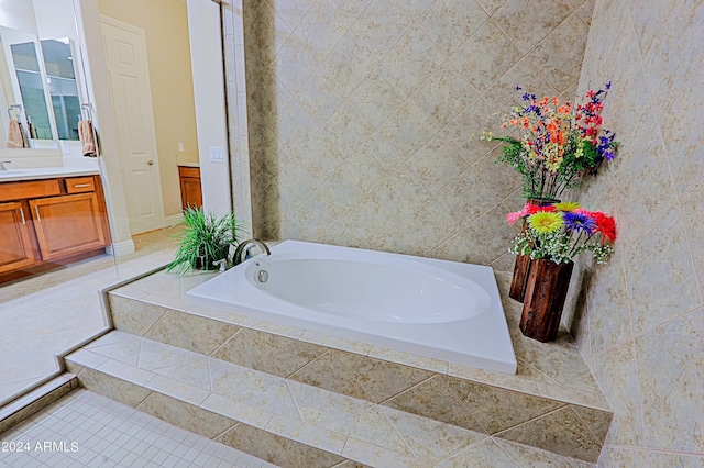 bathroom featuring vanity, a bath, and tile patterned flooring