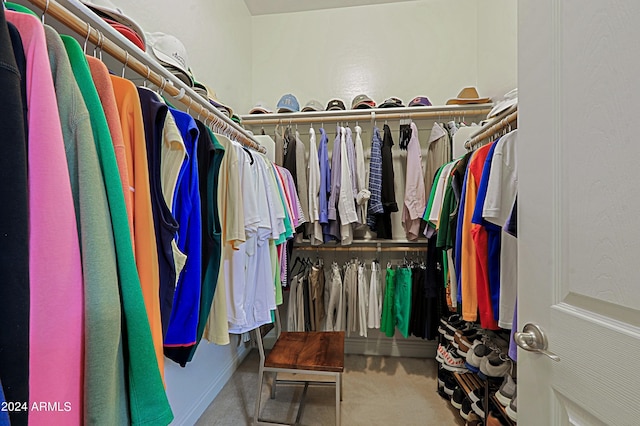 walk in closet featuring carpet flooring