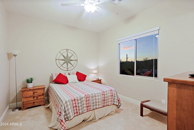 bedroom with ceiling fan, baseboards, and carpet floors