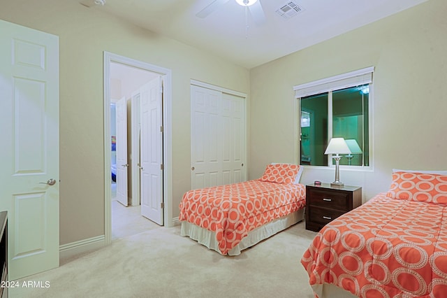 carpeted bedroom featuring baseboards, visible vents, a closet, and ceiling fan