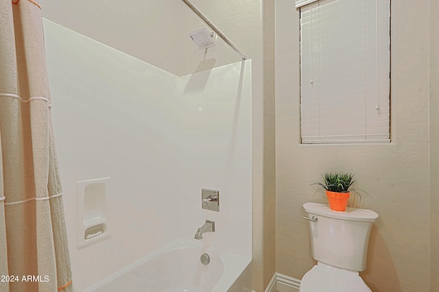 bathroom featuring toilet and  shower combination