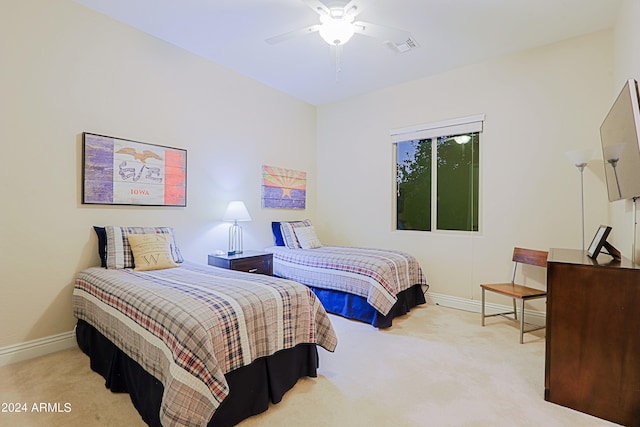 carpeted bedroom with visible vents, a ceiling fan, and baseboards