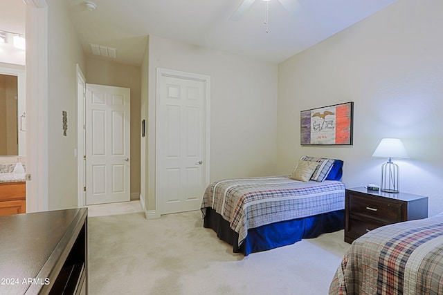 bedroom with visible vents, light carpet, and a ceiling fan
