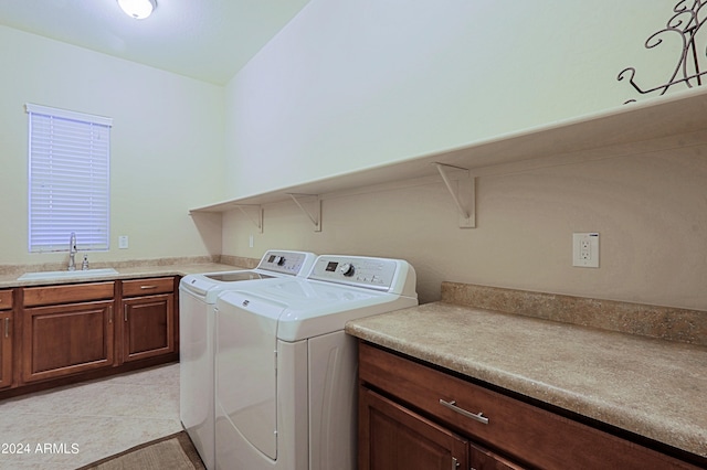laundry room featuring a sink, washing machine and dryer, laundry area, and light tile patterned floors