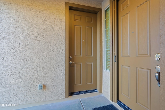 entrance to property featuring stucco siding