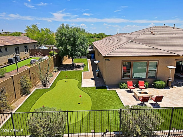 rear view of house with a patio, an outdoor fire pit, a fenced backyard, stucco siding, and a tile roof