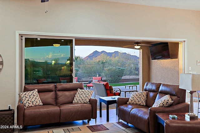 living room featuring tile patterned floors and a ceiling fan