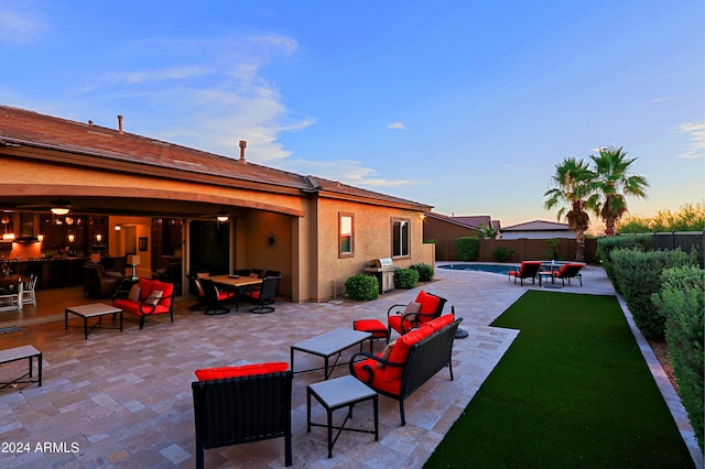 view of patio / terrace featuring outdoor lounge area, area for grilling, a fenced backyard, and a fenced in pool