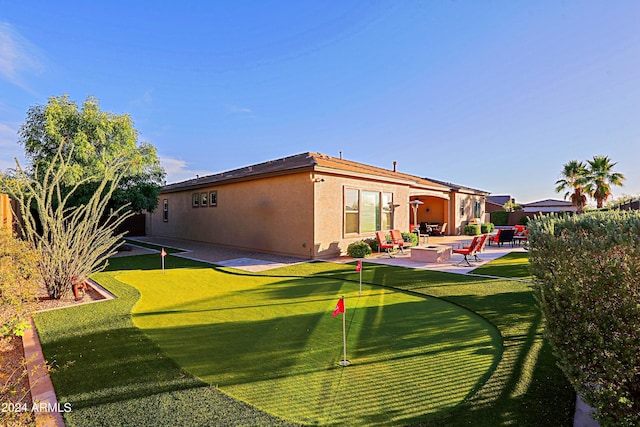 back of house with stucco siding, a patio, and fence
