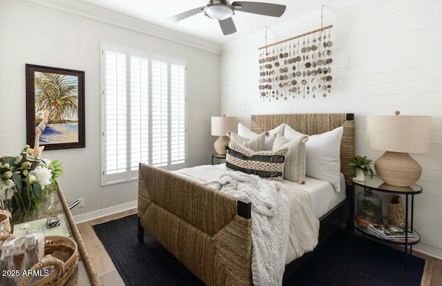 bedroom with multiple windows, ceiling fan, hardwood / wood-style floors, and ornamental molding