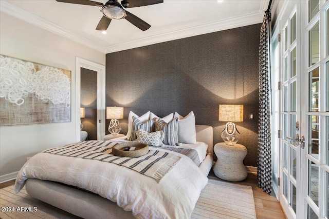 bedroom with crown molding, ceiling fan, french doors, and wood-type flooring