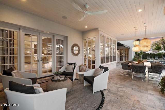 patio terrace at dusk featuring ceiling fan, french doors, and an outdoor hangout area