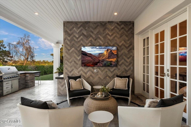 view of patio featuring french doors, area for grilling, and exterior kitchen