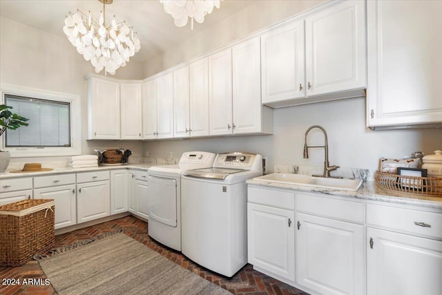 washroom featuring cabinets, separate washer and dryer, a notable chandelier, and sink