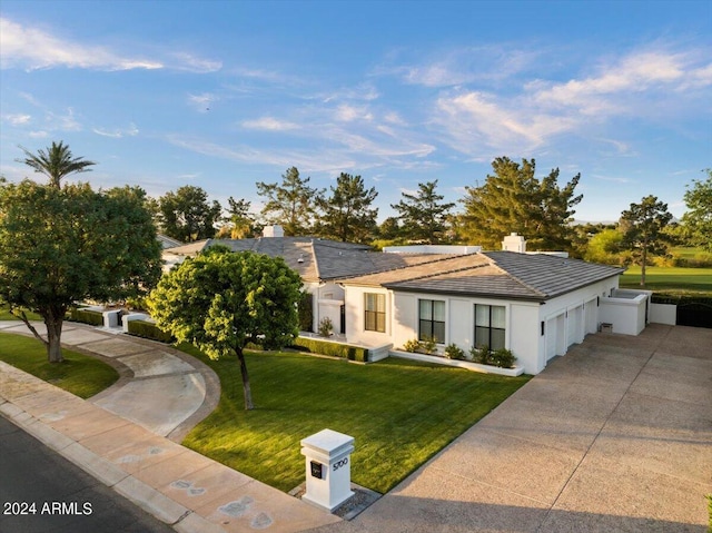 ranch-style home with a front yard and a garage