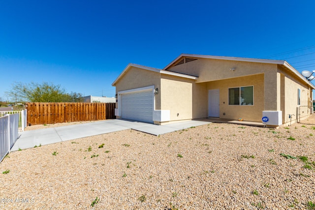 rear view of property with a garage