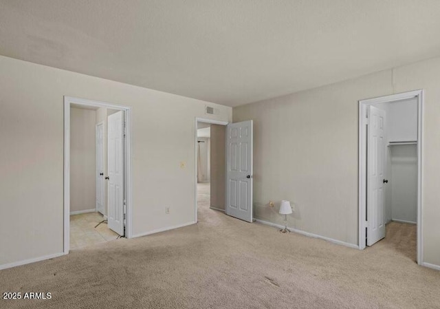 1402 E Guadalupe Rd Unit 215, Tempe, AZ 85283 - unfurnished bedroom with a walk in closet, carpet, and baseboards