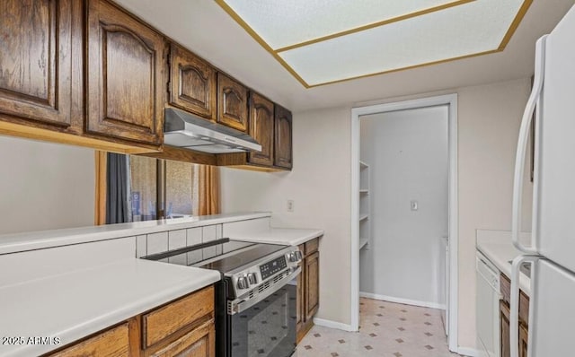 1402 E Guadalupe Rd Unit 215, Tempe, AZ 85283 - kitchen with white appliances, light flooring, under cabinet range hood, light countertops, and baseboards