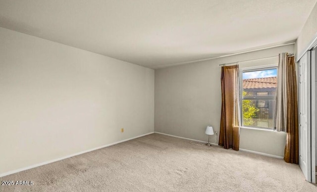 1402 E Guadalupe Rd Unit 215, Tempe, AZ 85283 - spare room featuring light carpet and baseboards