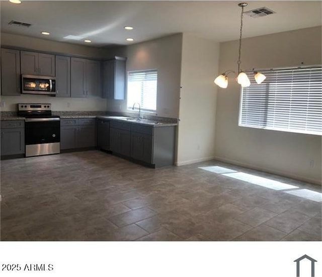 kitchen with gray cabinets, visible vents, and stainless steel appliances