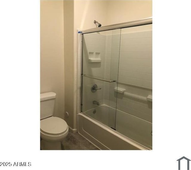 full bathroom with toilet and bath / shower combo with glass door