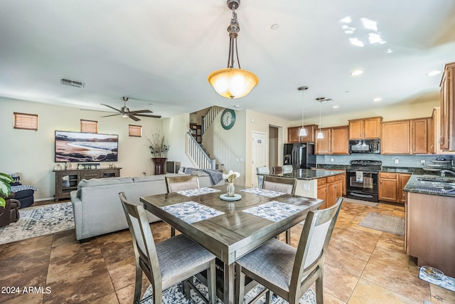 dining room with ceiling fan and sink