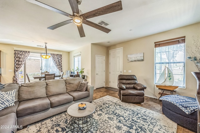 living room with ceiling fan and a healthy amount of sunlight