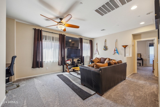 carpeted living room with ceiling fan