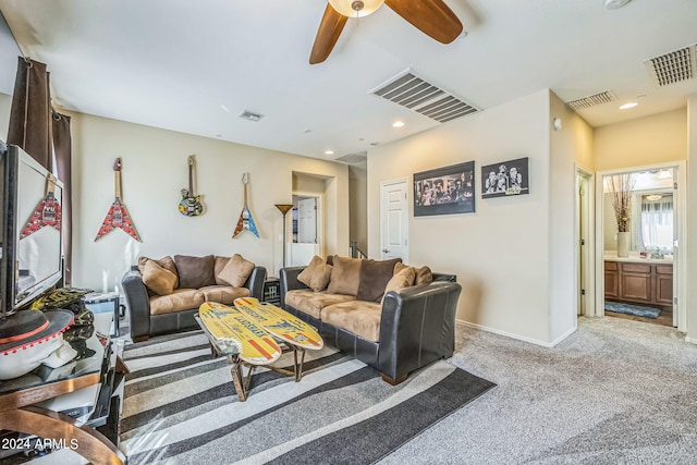 living room featuring ceiling fan, light colored carpet, and sink