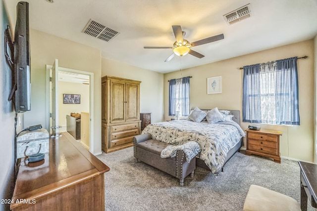 carpeted bedroom with multiple windows and ceiling fan