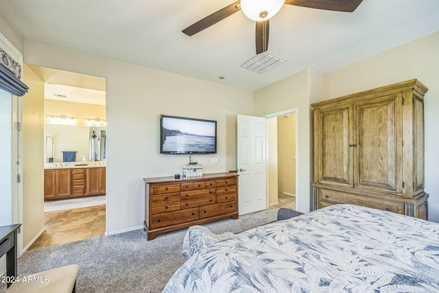 carpeted bedroom featuring ceiling fan and ensuite bathroom