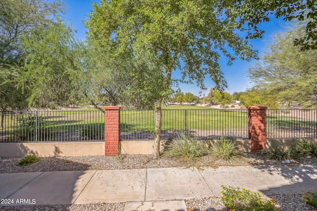 view of gate featuring a lawn