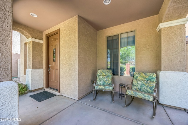 entrance to property featuring a patio area