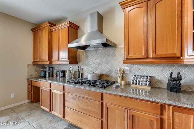 kitchen with black gas cooktop, light stone countertops, backsplash, and wall chimney exhaust hood