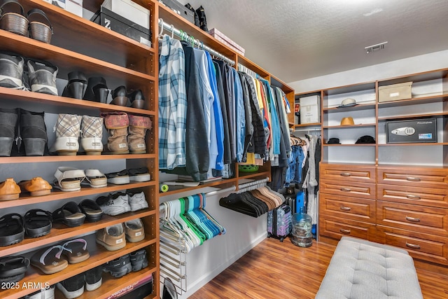 walk in closet featuring visible vents and wood finished floors