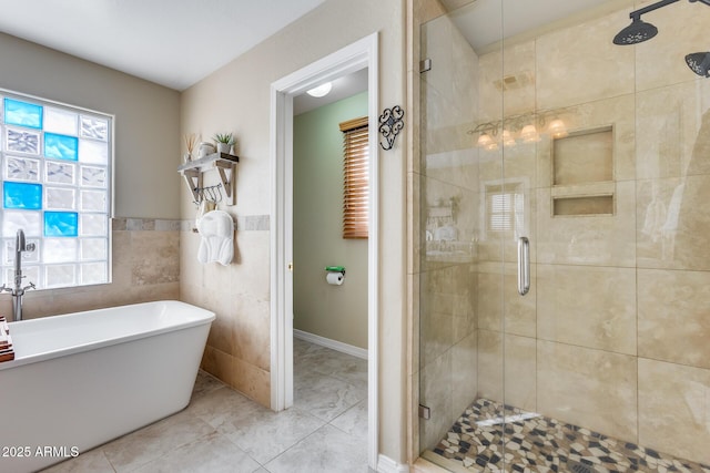 bathroom with a shower stall, tile walls, and a freestanding tub