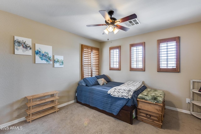 bedroom featuring visible vents, multiple windows, carpet, and baseboards