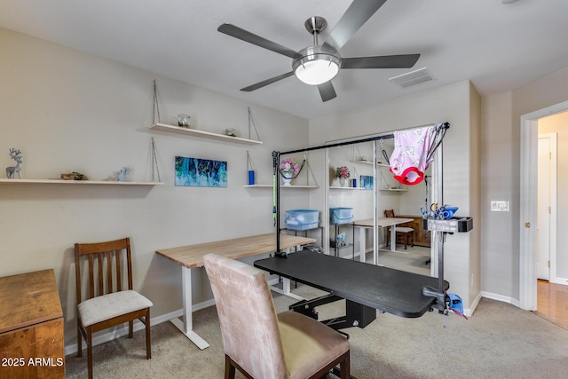 office space featuring visible vents, baseboards, a ceiling fan, and carpet flooring