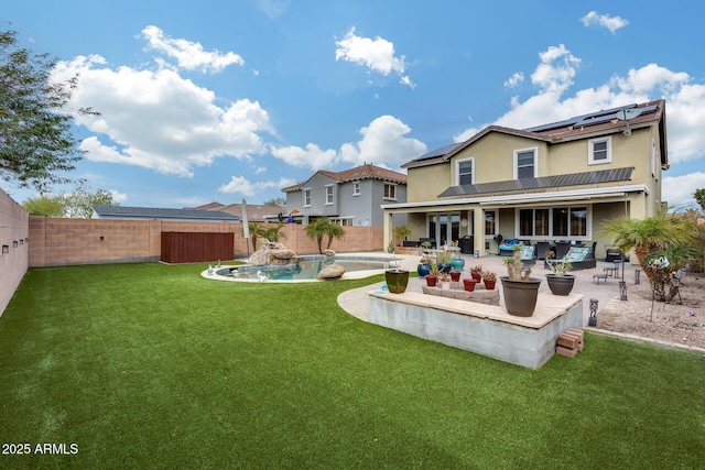 back of house with a lawn, a fenced backyard, a fenced in pool, solar panels, and a patio area