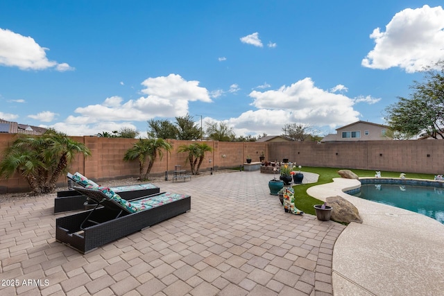 view of patio / terrace with a fenced backyard and a fenced in pool