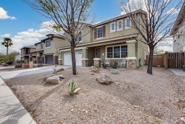 view of front of home with a porch, an attached garage, and stucco siding