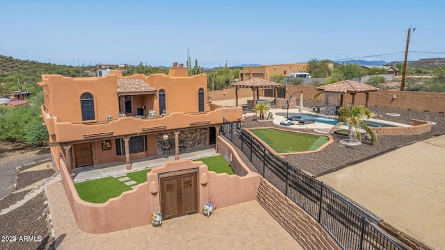 47012 N New River Rd, New River, AZ 85087 - view of front of home featuring a gazebo, a putting green, a patio area, and stucco siding