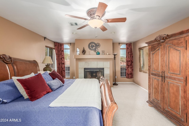 47012 N New River Rd, New River, AZ 85087 - bedroom with light carpet, a tile fireplace, baseboards, and ceiling fan