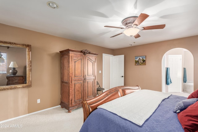 47012 N New River Rd, New River, AZ 85087 - bedroom with arched walkways, light carpet, ensuite bath, a ceiling fan, and baseboards