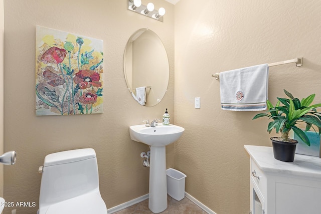 bathroom featuring tile patterned flooring, sink, and toilet