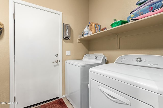 washroom featuring dark tile patterned floors and separate washer and dryer